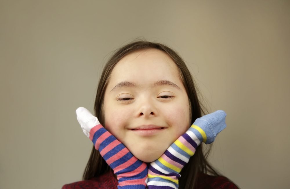 Beautiful girl smiling with different socks